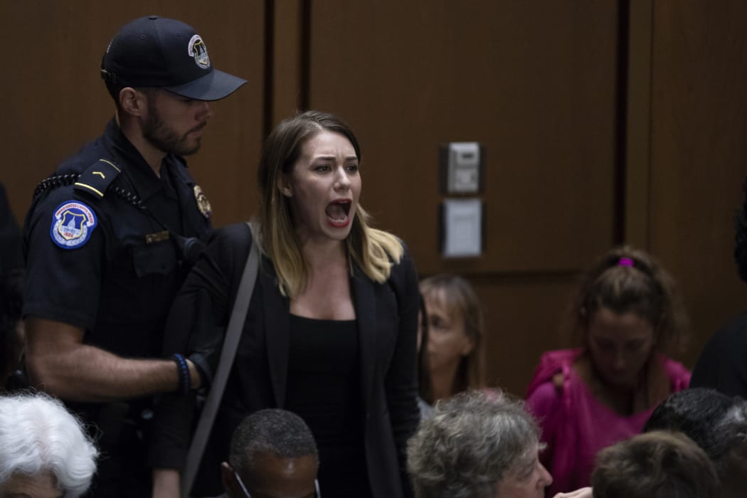A demonstrator shouts as Judge Brett Kavanaugh arrives prior to a hearing before the United States Senate Judiciary Committee on his nomination as Associate Justice of the US Supreme Court.