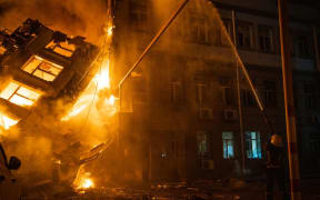 This handout photograph taken and released by Ukrainian Emergency Service on July 20, 2023 shows rescuers extinguishing a fire at an administrative building in Odesa as a result of missile strike, amid the Russian invasion in Ukraine. (Photo by Handout / Ukraine Emergency Service / AFP)