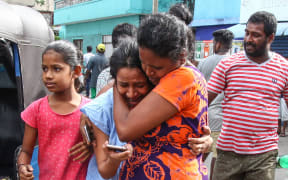 Sri Lankans living near St. Anthony's shrine run for safety after police found explosive devices in a van in Colombo, Sri Lanka on April 22, 2019.