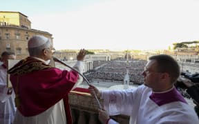 This photo taken and handout on May 7, 2025 by The Vatican Media shows Newly elected Pope Leo XIV, Robert Prevost addressing the crowd from the main central loggia balcony of the St Peter's Basilica for the first time, after the cardinals ended the conclave, in The Vatican. (Photo by Handout / VATICAN MEDIA / AFP) / RESTRICTED TO EDITORIAL USE - MANDATORY CREDIT "AFP PHOTO / VATICAN MEDIA" - NO MARKETING - NO ADVERTISING CAMPAIGNS - DISTRIBUTED AS A SERVICE TO CLIENTS
