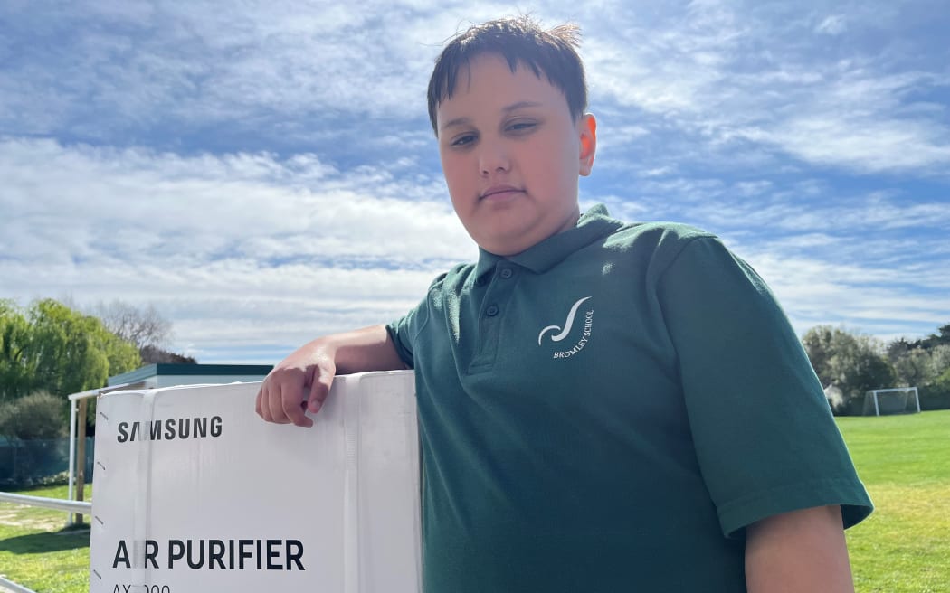 Connor McCallum with the family’s new air purifier.