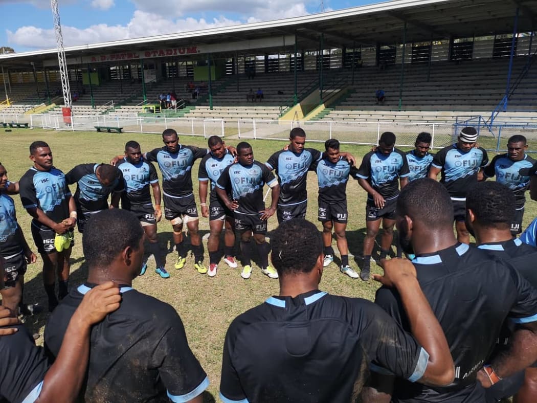 The Fijian Drua squad huddle together during training.