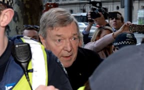 Cardinal George Pell arrives under heavy police protection for a filing hearing at the Melbourne Magistrates Court after being charged with sexual assault offences in Melbourne, July 26, 2017.