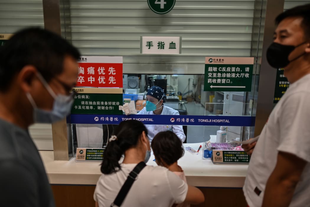 A medical worker conducts blood testing on patients in Tongji Hospitai, in Wuhan on September 3, 2020, while local authorities made a visit with media to the hospital.