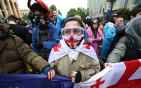 Georgian protesters rally against the controversial "foreign influence" bill in Tbilisi on May 14, 2024. Georgia's parliament on May 14, 2024 adopted a controversial "foreign influence" law that has sparked weeks of mass protests against the measure, denounced as mirroring Russian legislation used to silence dissent. The bill requires non-governmental organisations and media outlets that receive more than 20 percent of their funding from abroad to register as bodies "pursuing the interests of a foreign power." (Photo by Giorgi ARJEVANIDZE / AFP)