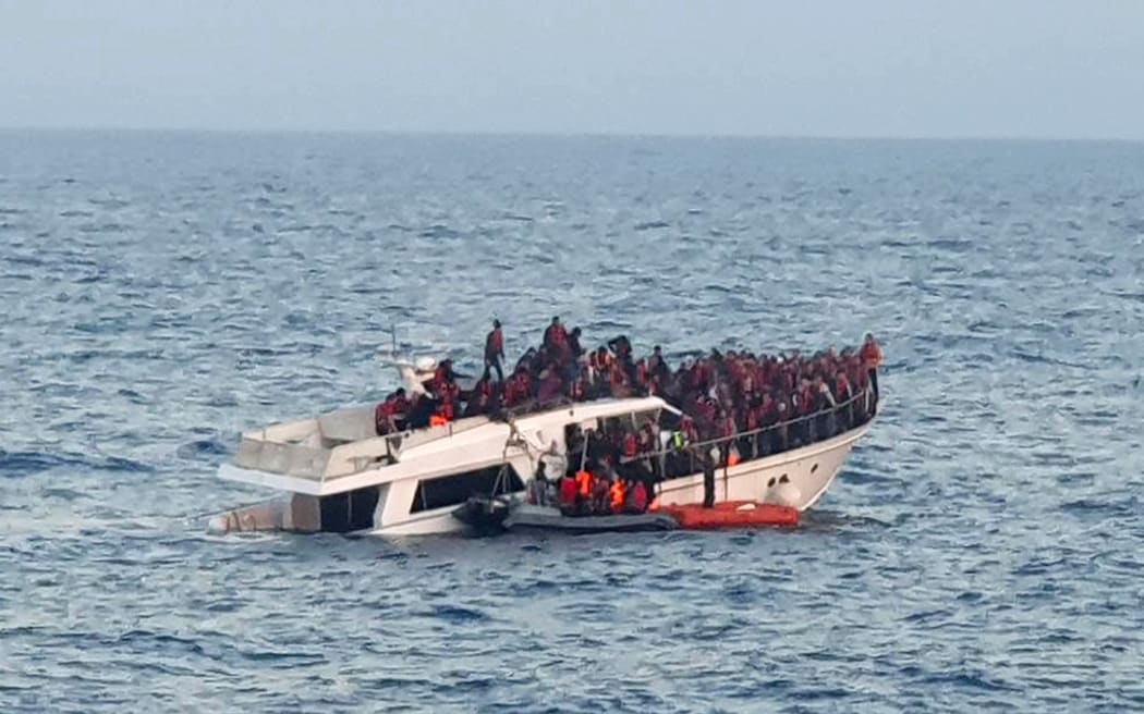 A sinking migrant boat in Mediterranean waters, off coast of Lebanon near Tripoli during a rescue operation by the Lebanese navy, on 31 December 2022.