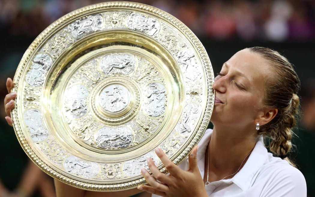 Czech Petra Kvitova kisses the Wimbledon trophy after winning her second grand slam.