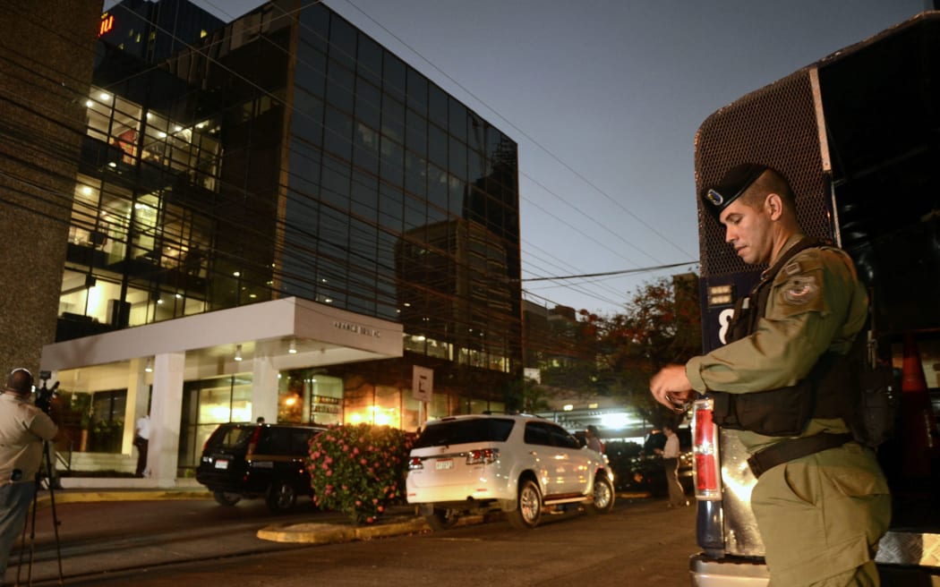 Police stand guard outside the Mossack Fonseca law firm offices in Panama City during the raid.