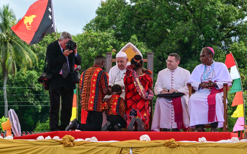 Pope Francis meets people as he takes part in a meeting with Catholic faithful of the diocese of Vanimo in front of Holy Cross Cathedral in Vanimo, Papua New Guinea, on September 8, 2024. (Photo by Tiziana FABI / AFP)