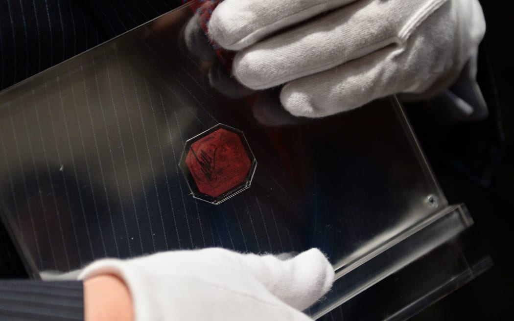 David Redden, Sotheby's Vice Chairman, holds the British Guiana One Cent Magenta after it sold for $US9.5m at Sotheby's June 17, 2014 in New York.