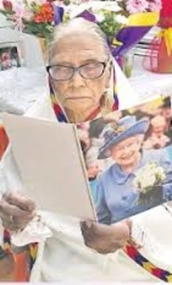 100-year-old Martha Vir reads her congratulatory letter from the Queen on her birthday at her home in Auckland on July 10.