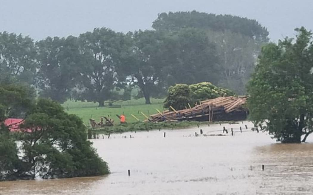 Flood waters surround a derailed train in Te Puke.