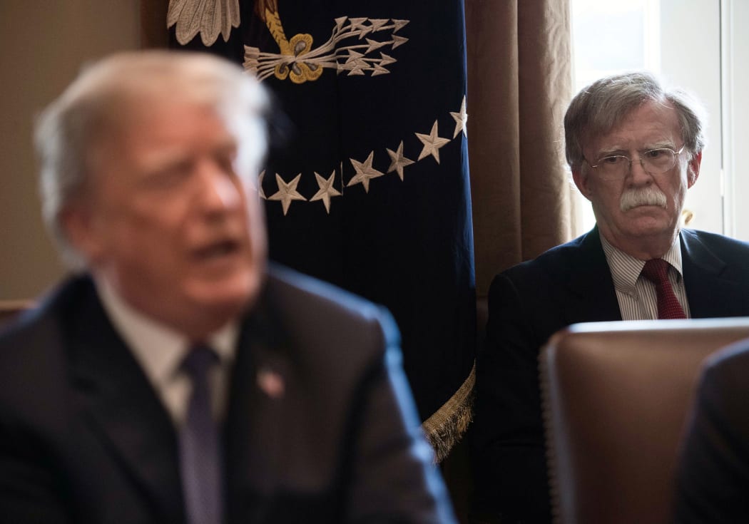 (FILES) In this file photo taken on April 9, 2018 New National Security Adviser John Bolton(R) listens to US President Donald Trump speak during a cabinet meeting at the White House in Washington, DC.