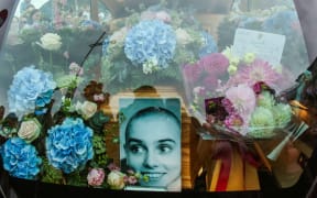 A photograph taken on August 8, 2023 shows the coffin and a picture of late Irish singer Sinead O'Connor, in the hearse during her funeral procession outside her former home in Bray, eastern Ireland, ahead of her funeral on August 8, 2023. A funeral service for Sinead O'Connor, the outspoken singer who rose to international fame in the 1990s, is to be held on Tuesday in the Irish seaside town of Bray. (Photo by PAUL FAITH / AFP)