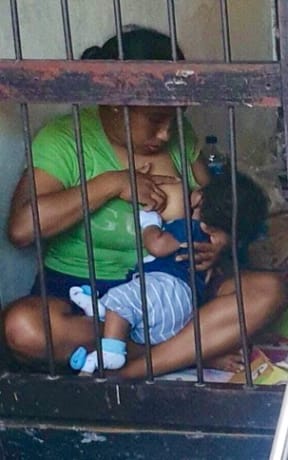 Sayang Mandabayan breast feeds her one-year-old in prison.