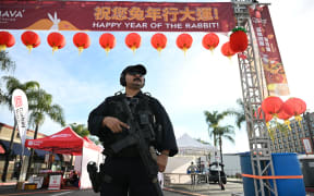 A police officer stands at the scene of a mass shooting in Monterey Park, California, on January 22, 2023.
