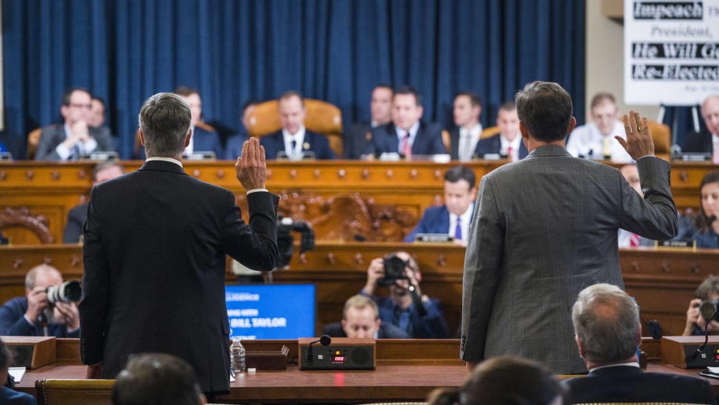 Charge d'Affaires at the US embassy in Ukraine Bill Taylor (left) and Deputy Assistant Secretary of State for Europe and Eurasia George Kent (right) are sworn in to testify before the House Permanent Select Committee on Intelligence hearing on the impeachment inquiry into President Trump