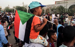 KHARTOUM, SUDAN - APRIL 10: Sudanese protesters, demanding the resignation of Sudanese President Omar Al-Bashir, stage a demonstration against high cost of living, fuel and cash shortage in front of army headquarters building in Khartoum, Sudan.