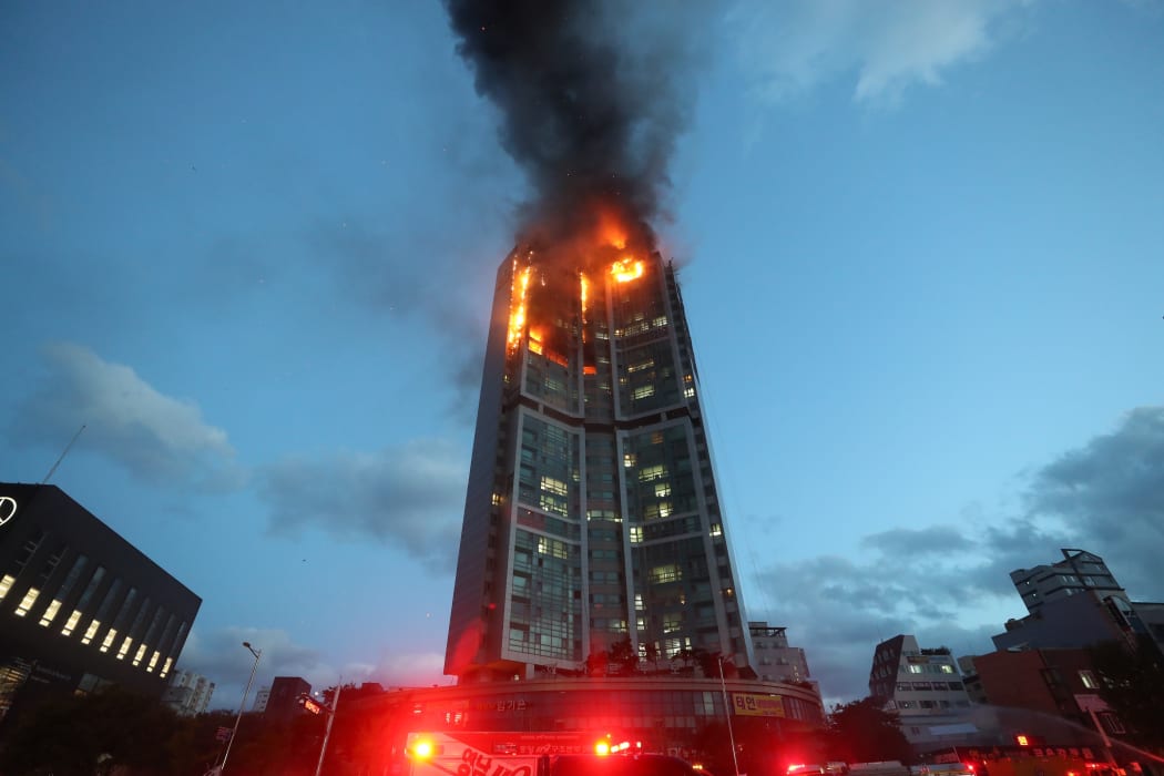 Flames and smoke rise from a fire at an apartment building in Ulsan.