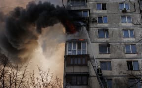 KYIV, UKRAINE - MARCH 15: Firefighters respond a fire erupted after an apartment building hit by Russian attacks in Kyiv, Ukraine on March 15, 2022. Fire erupts after 16-story apartment building shelled in Sviatoshynskyi district in Kyiv.
