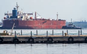 A crude oil tanker is anchored on Lake Maracaibo near Maracaibo, Zulia state, Venezuela, on December 18, 2025. Venezuela struck a defiant note on December 17, insisting that its crude oil exports were not impacted by US President Donald Trump's announcement of a potentially crippling blockade. (Photo by Alejandro Paredes / AFP)