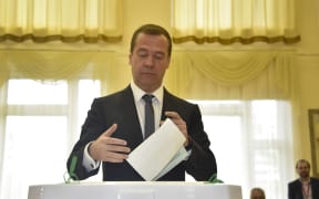 Russian Prime Minister Dmitry Medvedev prepares to cast his ballot for Russia's parliamentary election.