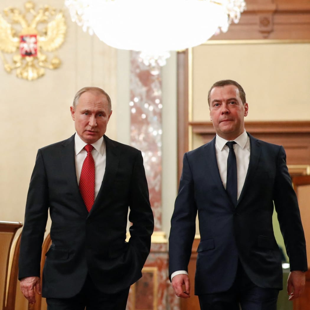 Russian President Vladimir Putin and Russia's Security Council deputy chairman Dmitry Medvedev walk before a meeting with members of the government in Moscow on January 15, 2020.
