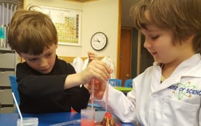 Two children doing a science experiment