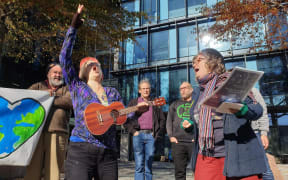 Singers protest outside Canterbury Regional Council office.