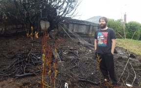 Daniel Davidson in his burned back yard.