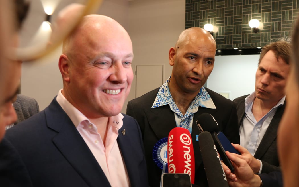 Tama Potaka speaks to reporters with National Party leader Christopher Luxon after the preliminary results are counted.