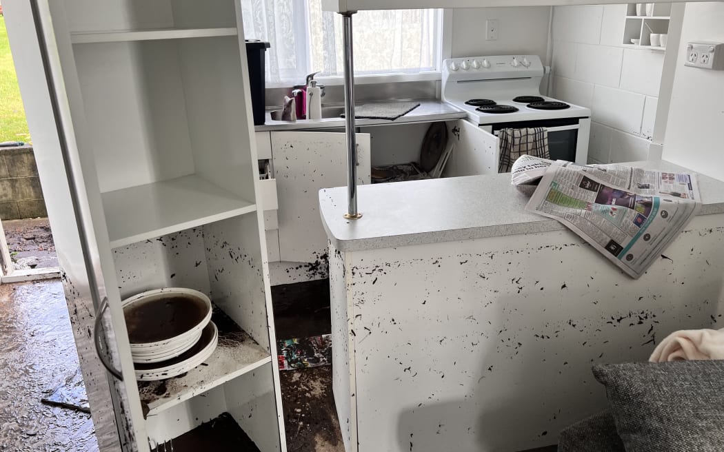 Floodwater left mud through a pensioner unit at Waihī Beach.