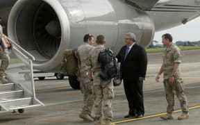 Troops returning from Iraq are welcomed by Defence Minister Gerry Brownlee and Commander Joint Forces New Zealand Major General Tim Gall, at the Ohakea Air Force Base on 16 November 2015.