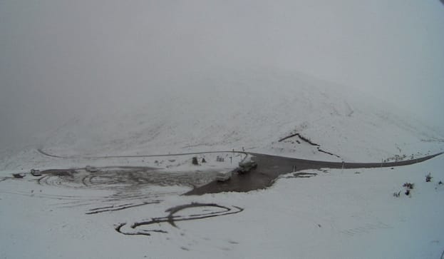 Crown Range Road closed yesterday after being blanketed with snow.
