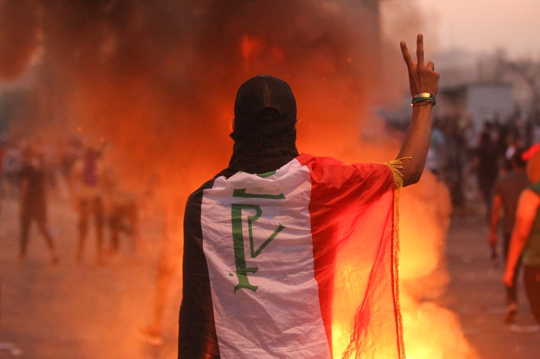 Iraq's president and the United Nations urged security forces to show restraint after two protesters were killed in clashes with police that other top officials blamed on "infiltrators."