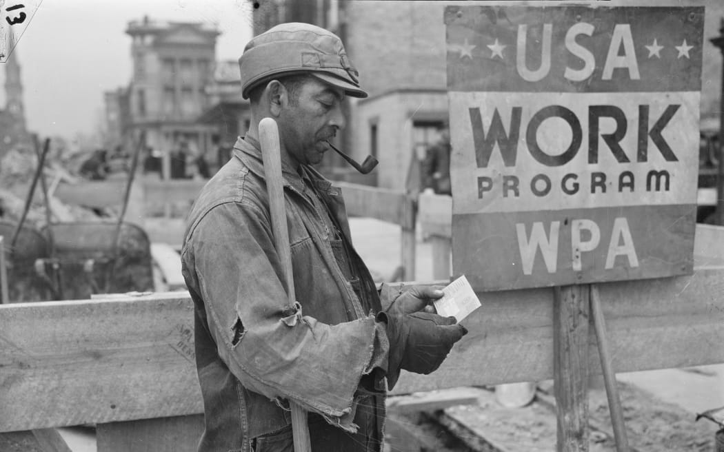 Worker receiving paycheck circa 1936