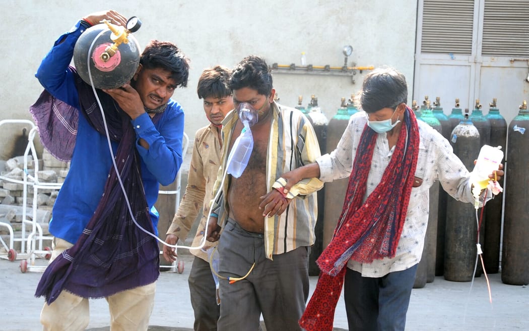 A Covid-19 patient from Lodhida village in Rajkot district with his attendants arrives at the 1200-bed Covid hospital inside the Civil Hospital campus in Ahmedabad on April 28, 2021.