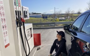 Jake fills fuel containers at Costco in  West Auckland.