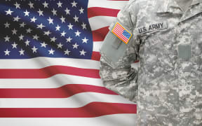 American soldier with flag on background - United States