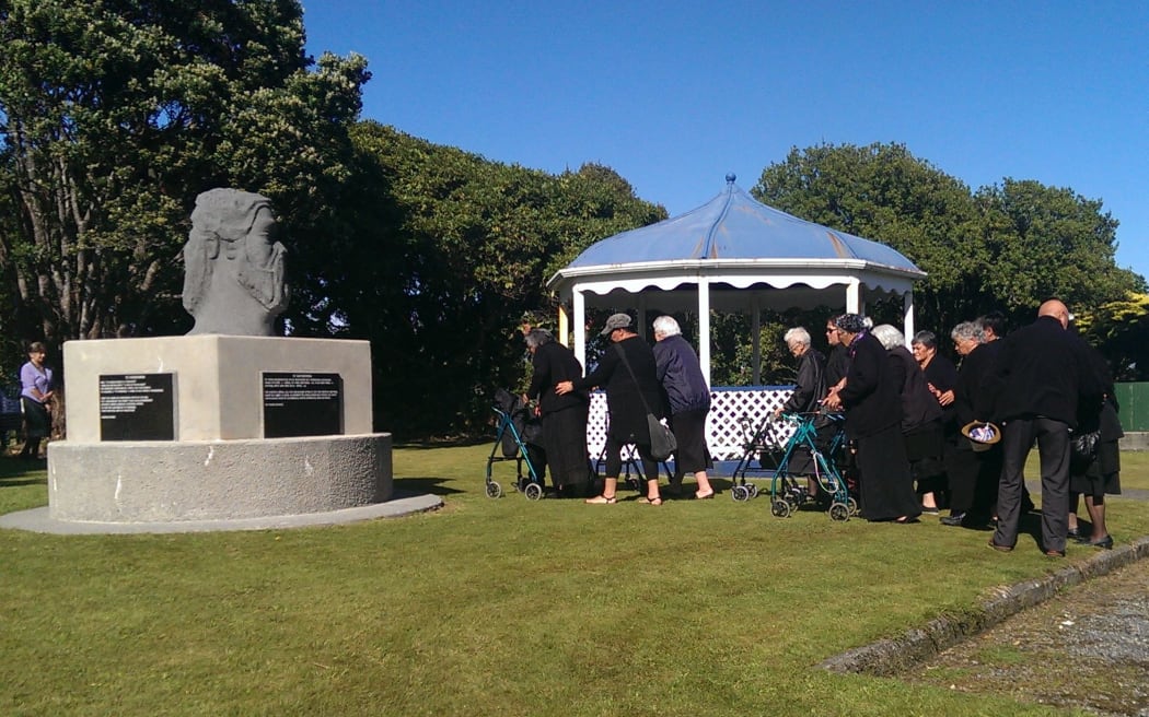 Ngaruahine people gathering in front of memorial stone at Seaview in Hokitika.