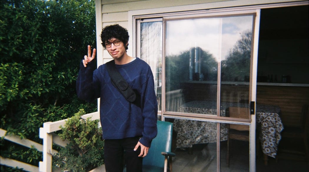Lukas Mayo throwing up a peace sign