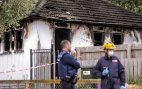 Police and fire investigators at the house this morning.