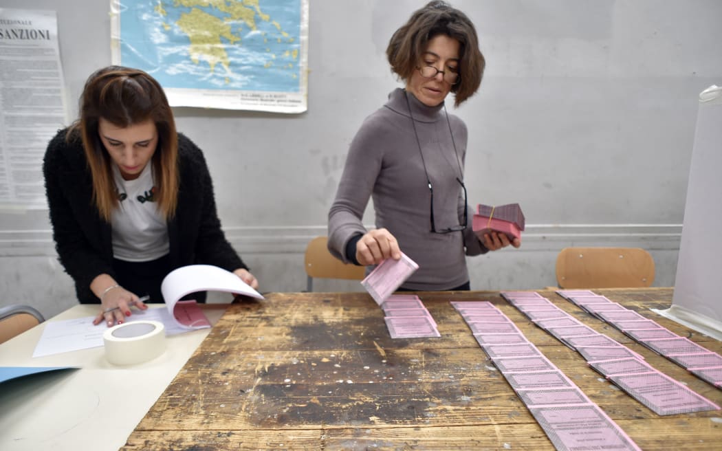 Polling station officers prepare ballots on the eve of a crucial referendum on constitutional reforms.