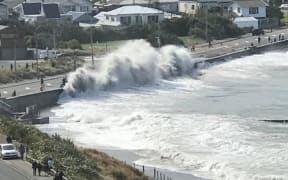 A wave crashes on to the road at Island Bay, Wellington, in a southerly swell.
