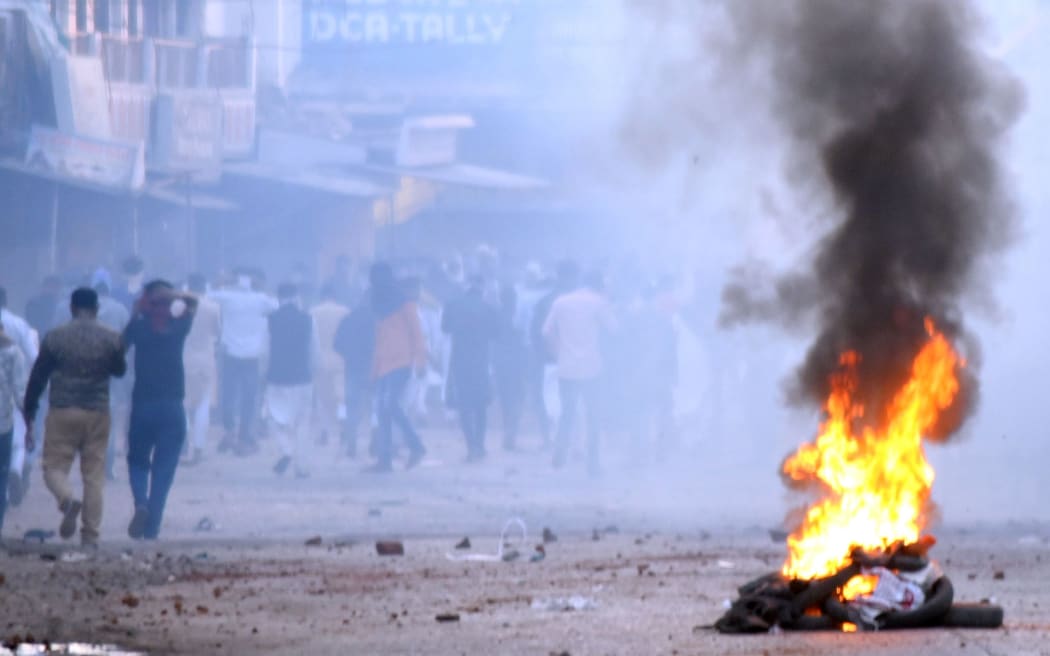 In this photograph taken on December 20, 2019, a fire burns as protesters take part in a rally against India's new citizenship Law in Jabalpur.
