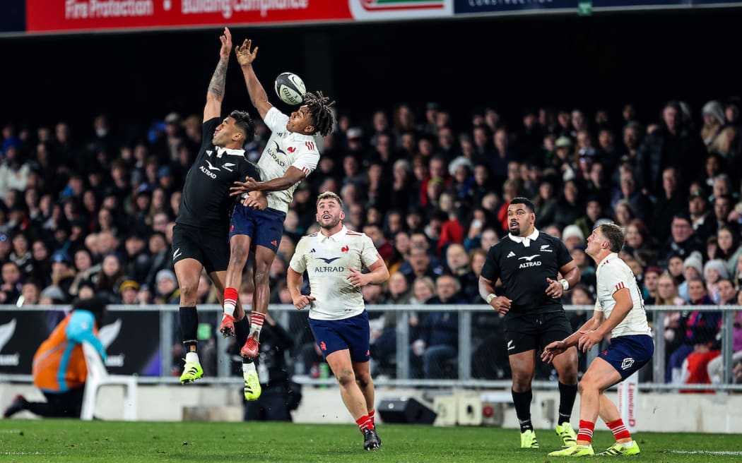  Rieko Ioane of New Zealand and Theo Attissogbe of France compete for the ball.