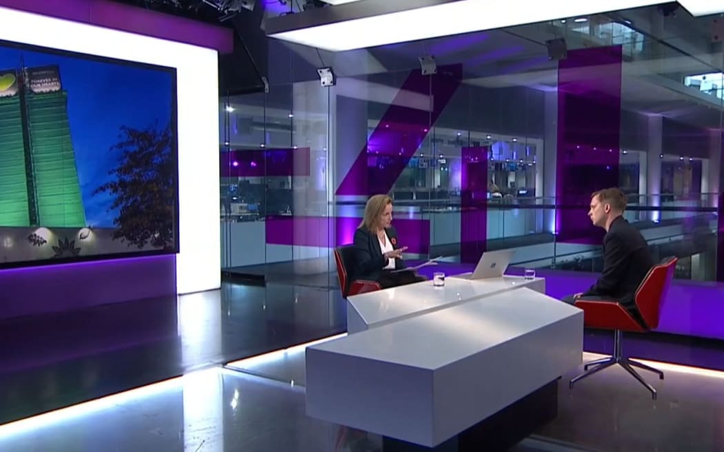 Peter Apps of UK publication Inside Housing with an mage of Grenfell Tower on UK's Channel 4.