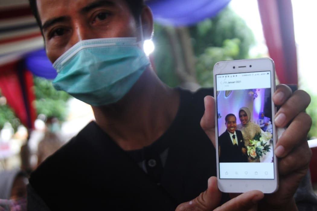 JAKARTA, INDONESIA - JANUARY 12: Slamet Bowo, the relative of the Sriwijaya Air SJ-182 plane crash shows a photo of his brother during his visit to the Police Hospital, Jakarta, Indonesia on Tuesday, January 12, 2021.