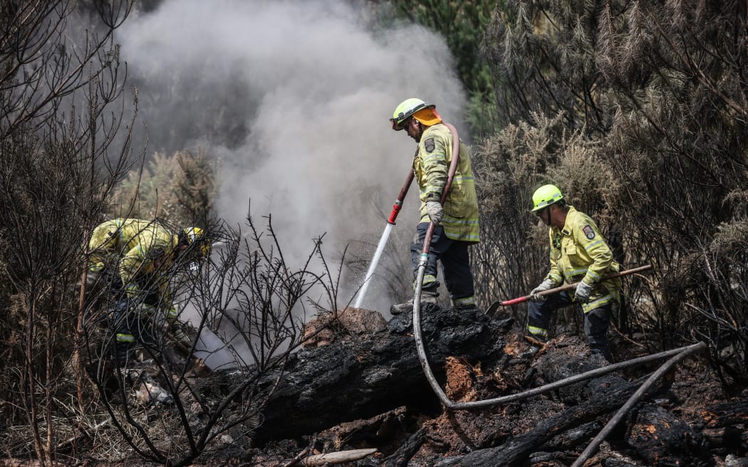 170224 CHRIS SKELTON / POOL
Firefighters continue their efforts on Saturday as they work to dampen down remaining hot spots and create a buffer zone around the 24km perimeter fire ground in Christchurch's Port Hills. Pictured left to right, Lee Reihana (City Care firefighter), John Hytongue (City Care firefighter), and Stephen Robson (Peel Forest Volunteer firefighter)