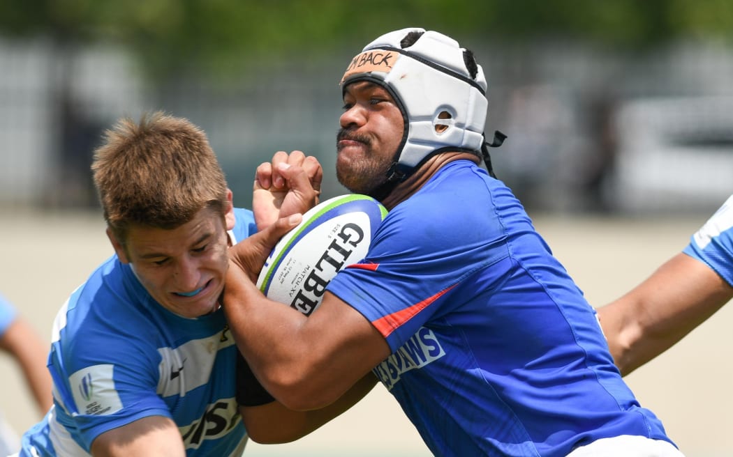 Samoa captain Losi Filipo tries to burst through the Argentina defence.